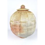 JIM BRASHEAR; a large wood fired stoneware jar and cover with incised and ribbed surface, incised