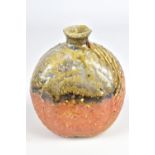 UWE LOELLMANN (born 1955); a small round wood fired stoneware bottle, impressed mark and dated 2012,