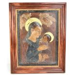 An early 20th century painted gesso panel depicting the Madonna and Child, 50 x 37cm, framed (af).
