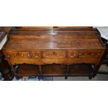 A small 18th century oak dresser base with six dummy drawers above frieze of five drawers on