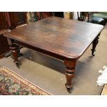 A large Victorian mahogany wind-out extending dining table with two extra leaves, raised on turned