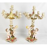 A pair of early 20th century Continental porcelain five branch candelabra, each with floral