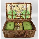 CORCOLE; a vintage wicker picnic basket and contents.Additional InformationExtensive wear