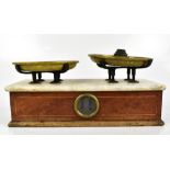 A set of mahogany kitchen scales with inlaid detail, marble top and brass pans, a set of graduated