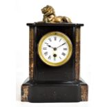 A Victorian slate and marble mantel clock with bronze metal lion surmount above circular enamel dial