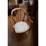 An Edwardian walnut open arm elbow chair.