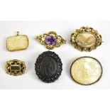 Six 19th century brooches, including two pinchbeck mourning examples, both set with hair, a