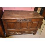An 18th century oak coffer, carved 'M E 1742' to frieze above three panelled front and two short