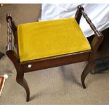 An Edwardian mahogany piano stool with hinged seat enclosing storage compartment on cabriole