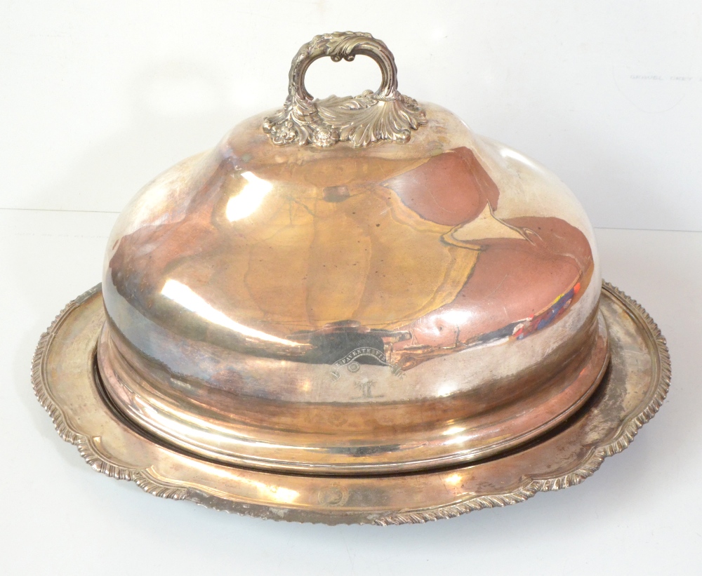 A silver plated meat dish, the associated domed cover with armorial device and motto 'TE FAVENTE
