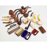 A collection of pipes and cheroot holders including Meerschaum examples, one cheroot holder with