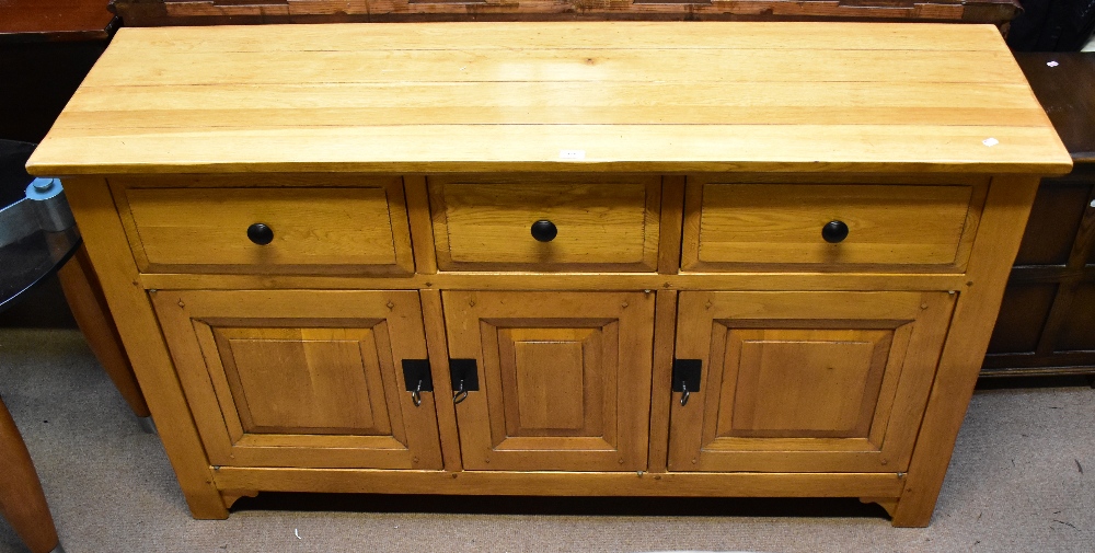 A reproduction oak dining suite comprising an extending dining table raised on block supports, - Image 2 of 2