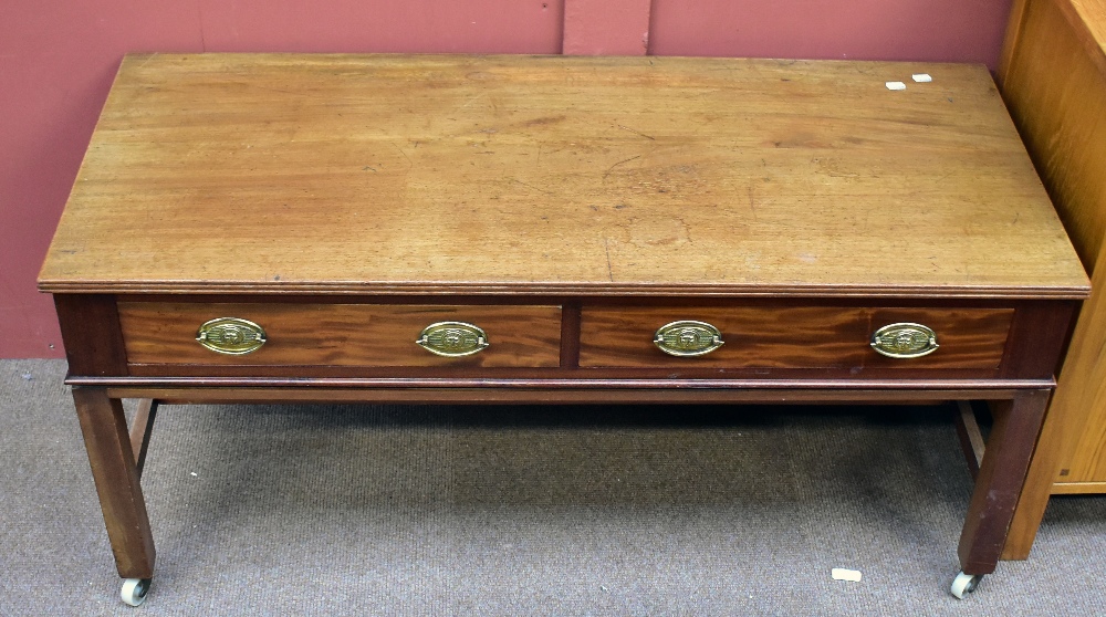 A mahogany coffee table with two short drawers (one af) on stretchered supports to castors, 56 x 119