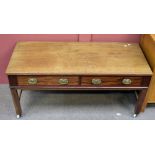 A mahogany coffee table with two short drawers (one af) on stretchered supports to castors, 56 x 119