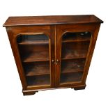 A Victorian mahogany bookcase with twin glazed doors, raised on bracket feet, width 114cm.Additional