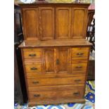A late 19th century oak housekeeper's cupboard, the upper section with four panelled cupboard