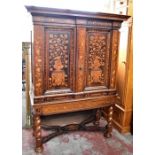 An early 19th century Dutch walnut and marquetry cabinet on stand, the upper section with twin doors
