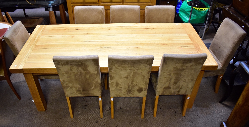 A reproduction oak dining suite comprising an extending dining table raised on block supports,