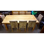 A reproduction oak dining suite comprising an extending dining table raised on block supports,