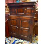A late 17th century oak court cupboard, the upper section with twin cupboard doors above a base of