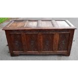 An 18th century panelled oak coffer with carved decoration to the front, height 70cm, length