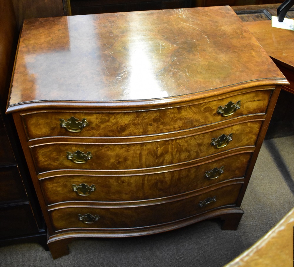 A reproduction burr walnut veneered serpentine front chest of four drawers, raised on bracket