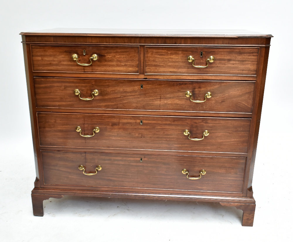An early 19th century mahogany straight front chest of two short over three long drawers, raised