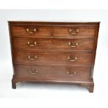An early 19th century mahogany straight front chest of two short over three long drawers, raised