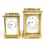 A circa 1900 French brass carriage clock with circular white enamel dial set with Roman numerals,