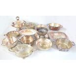 A group of silver plated items including a repoussé decorated bowl, a pedestal bowl, trays, etc.