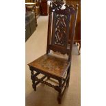 An 18th century oak hall chair with pierced back on bun feet, height 112.5cm.Additional