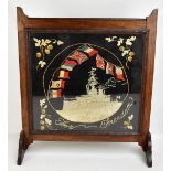 A WWI period tapestry panel depicting a battleship, inscribed 'For Freedom', set within carved oak