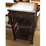 A 19th century Chinese rosewood table with inset marble top above carved and pierced floral