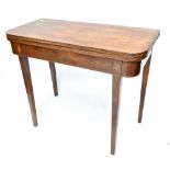 A George III mahogany foldover tea table, raised on tapering block supports, height 74cm, length