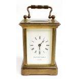 MATTHEW NORMAN; a reproduction brass cased miniature carriage clock, the enamelled dial set with