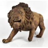 A carved treen model of a stalking lion, height 32cm, length 58cm (af).Additional InformationLarge