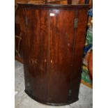 A Georgian mahogany bow-front corner cupboard, height 118.5cm, width 76cm. Additional