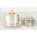 An Edwardian silver plated biscuit box of oval form with engine turned decoration, on four ball