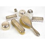 A matched hallmarked silver mounted eight piece dressing table set, comprising hair and clothes