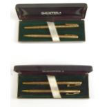 SHEAFFER; two cased 12ct gold filled propelling pen and pencil sets, each body with chased detail,