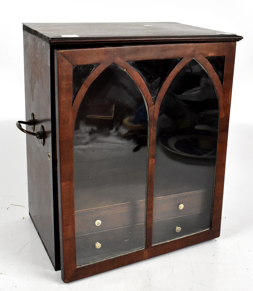 A 19th century mahogany table top cabinet, the single glazed door enclosing two drawers, with swan