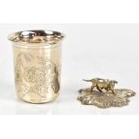 An 800 grade silver beaker with chased floral decoration and engraved initials KM, height 7cm, and a