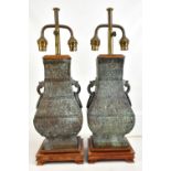 A pair of modern Chinese lamps in the form of archaic hu vases, height including base and fitment
