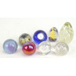 Eight contemporary glass paperweights to include a Mdina example, height 6cm.Additional