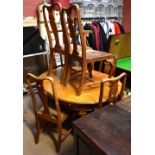 An early 20th century oak dining table with a set of seven Queen Anne style chairs with padded