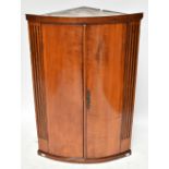 A Georgian mahogany bow-front corner cupboard, height 94cm, width 63cm.Additional