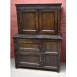 An 18th century and later oak cabinet on stand, the lower section with two panelled cupboard