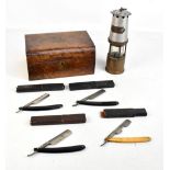 A Naylor Ltd of Wigan miners' safety lamp, a burr walnut sewing box with accessories and four