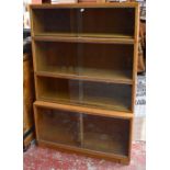 MINTY; an oak four tier bookcase with glazed sliding doors, height 124cm, width 89cm.Additional
