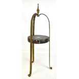 A homemade brass stand using a gong as the central platform with three supports, height 67cm.